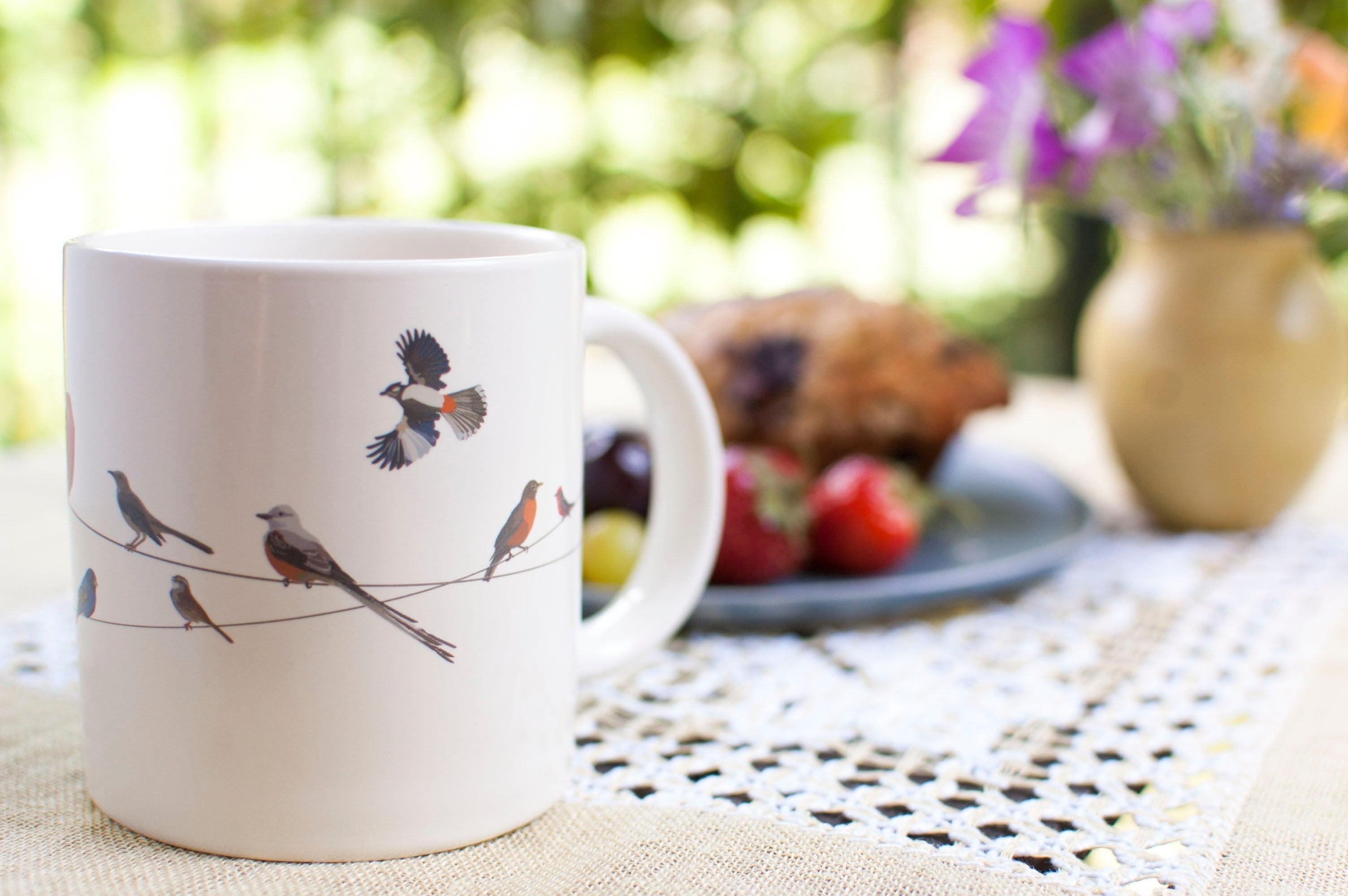 Product photo of Birds on a Wire Heat-Changing Mug, a novelty gift manufactured by The Unemployed Philosophers Guild.